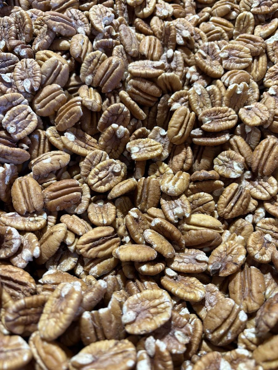Fresh shelled pecan halves piled in a bowl
