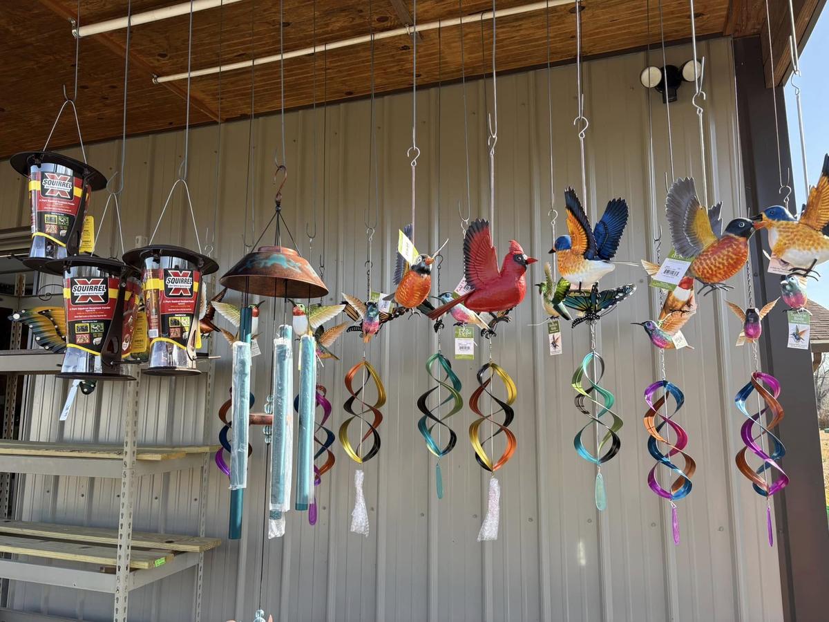 Wind chimes and metal bird ornaments on display