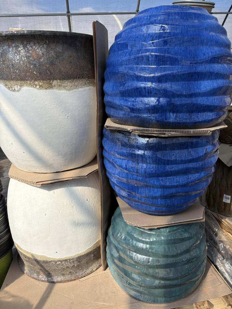 Stacked glazed ceramic planters in blue and cream tones